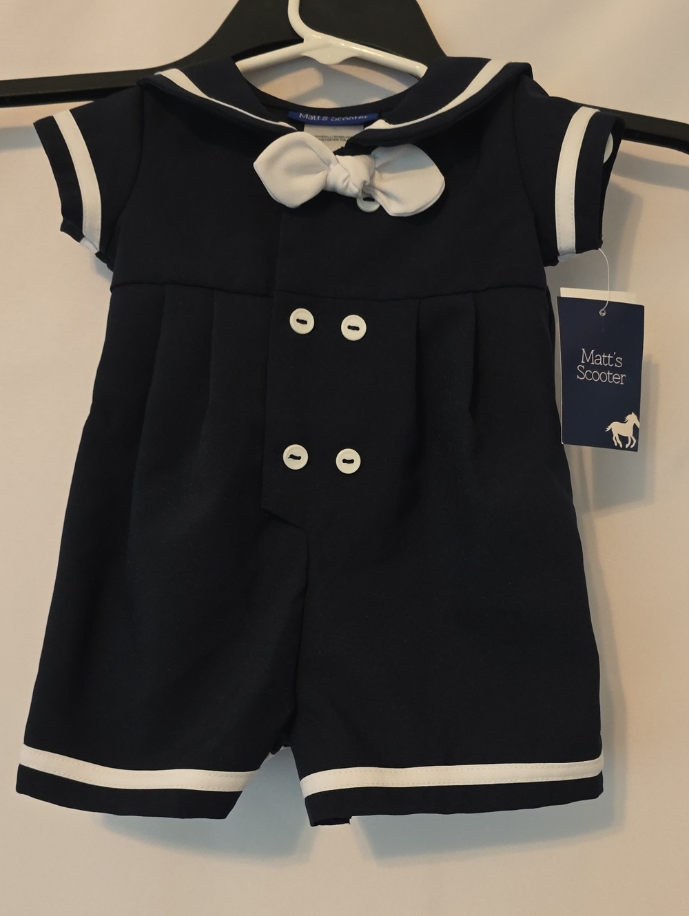 Adorable Matt’s Scooter baby boy sailor romper in classic navy blue and white